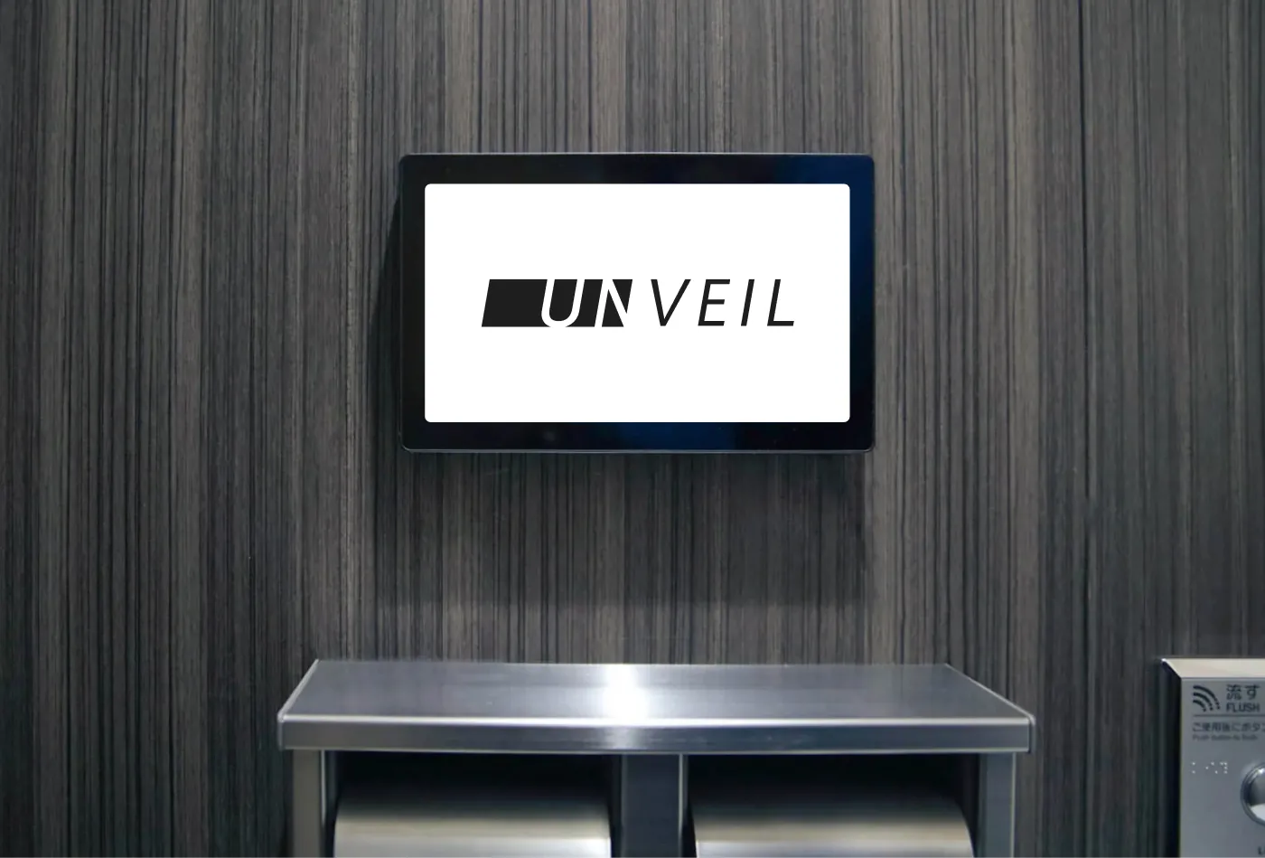 トイレの個室に設置した動画広告メディア「Unveil」